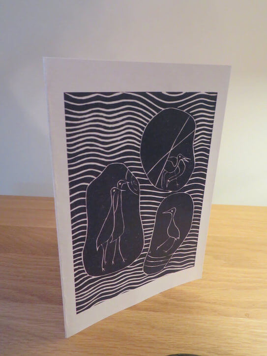 A lino print greetings card titled 'Pebble Birds'.